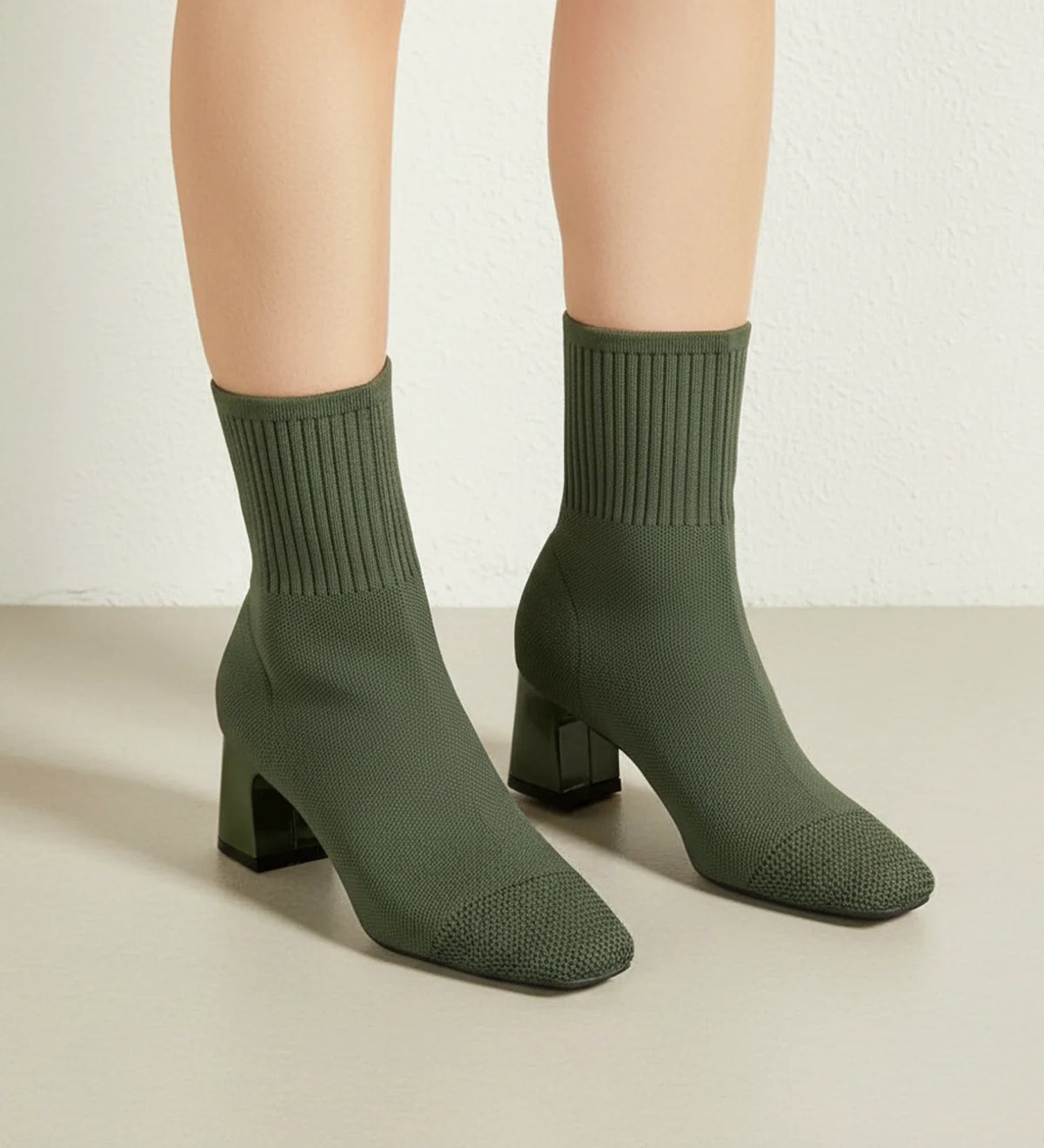 Women's black sock-knit ankle boots with block heel, sleek form-fitting silhouette for everyday elegance