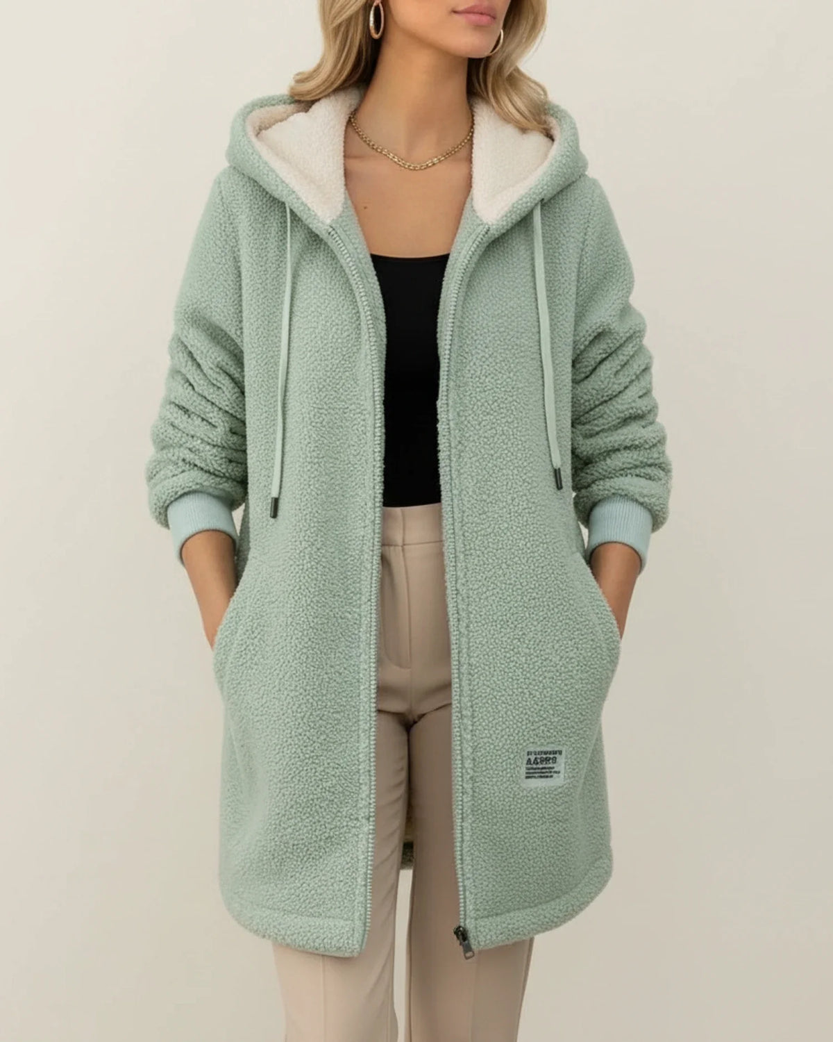 Women's longline hooded teddy coat with cozy fleece lining, zip-up front, and practical pockets