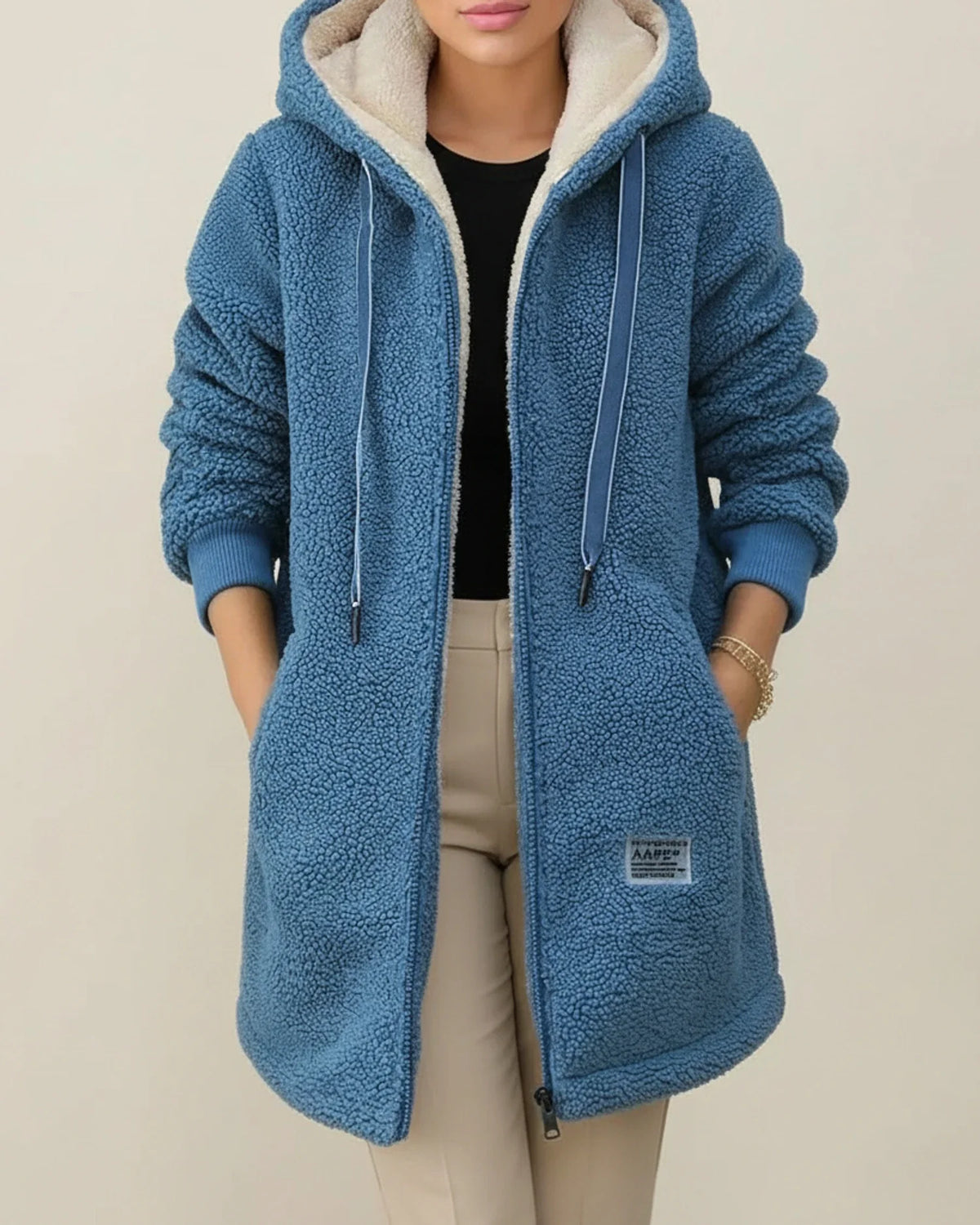 Women's longline hooded teddy coat with cozy fleece lining, zip-up front, and functional pockets