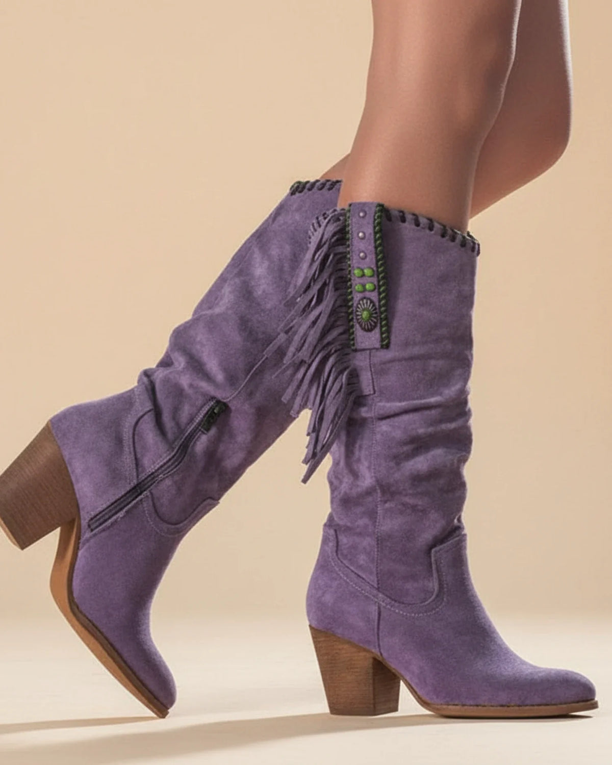 Women's knee-high Western boots in tan leather with classic stitching and a sleek elongated shaft