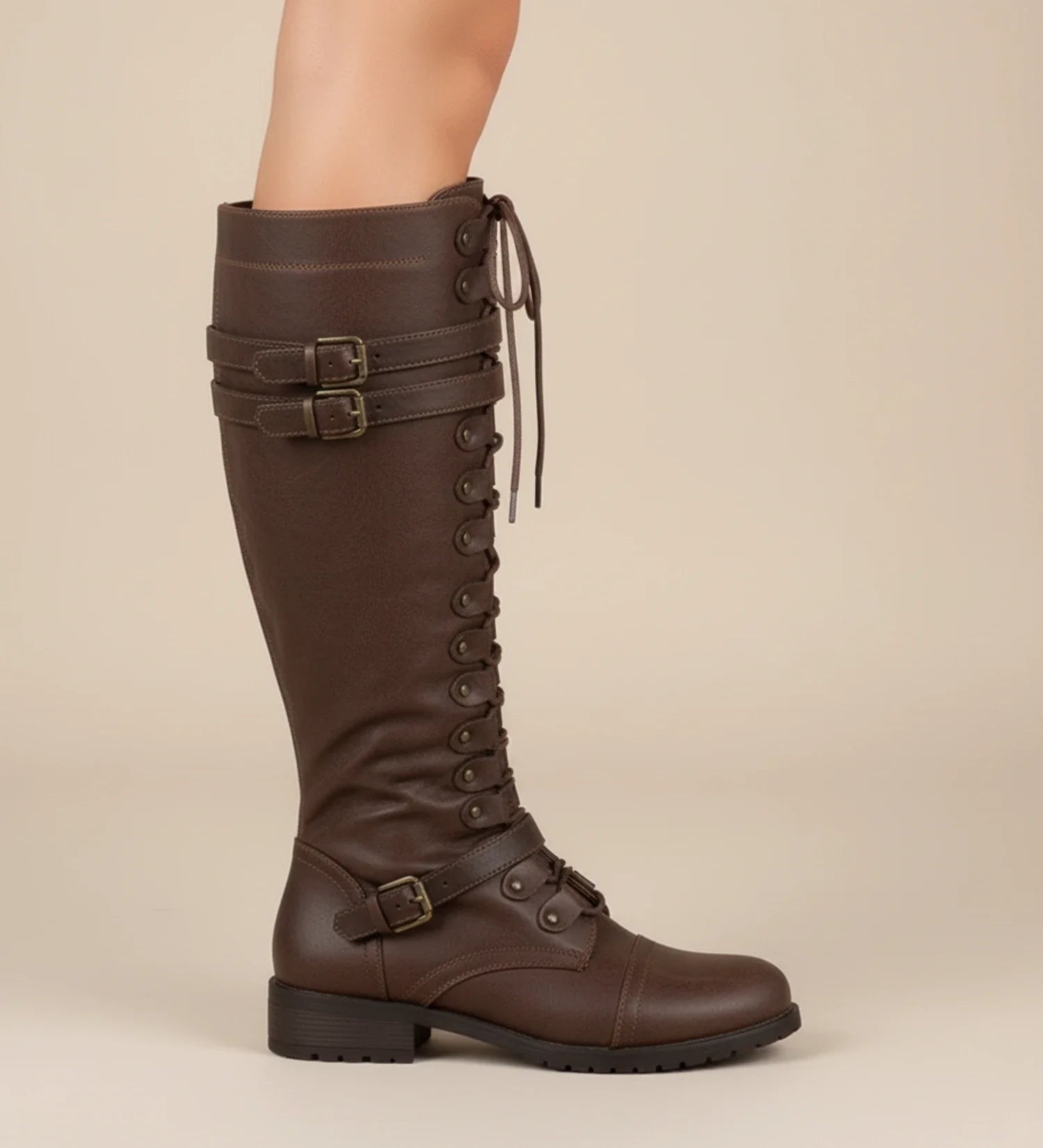 Women's black knee-high lace-up combat boots with buckle accent detail for edgy everyday style