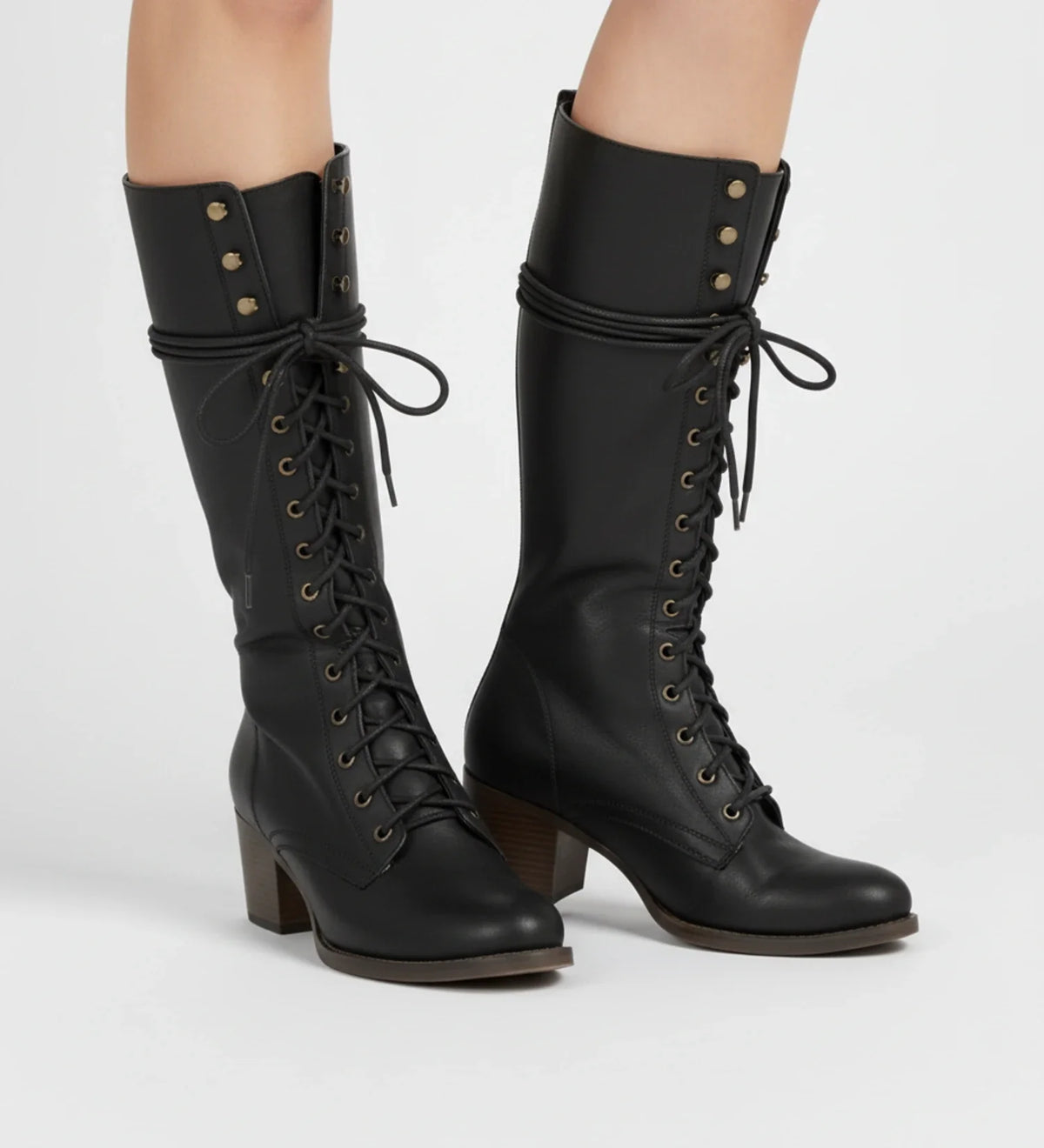 Women's black knee-high combat boots with block heel, lace-up front, grommet details, and back zipper