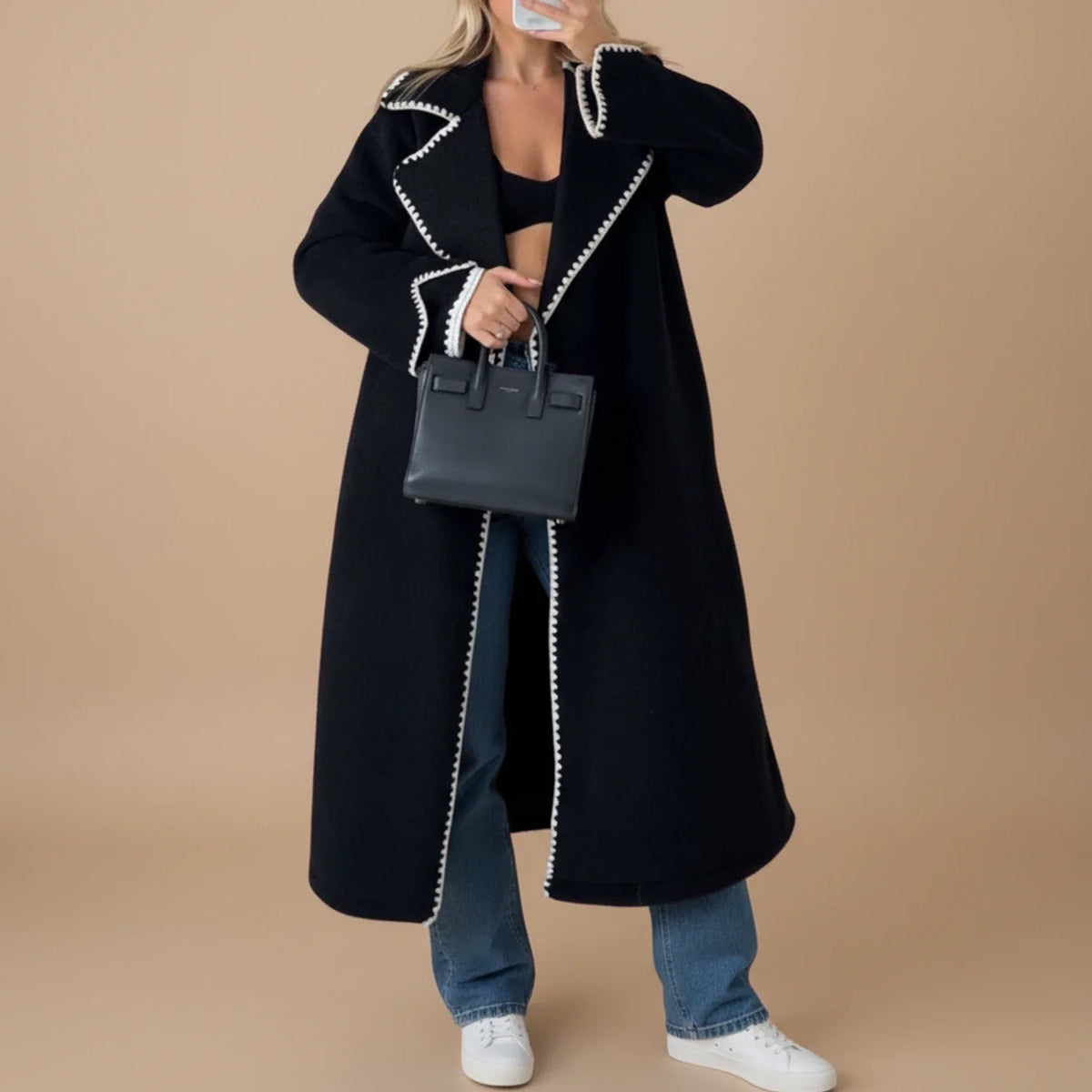 Women's longline duster coat in neutral tone with contrast trim and open-front relaxed fit
