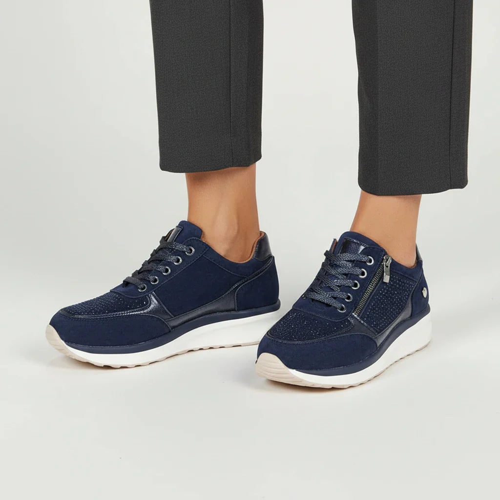 Women's white platform sneakers with side zip detail and cushioned sole for casual everyday wear