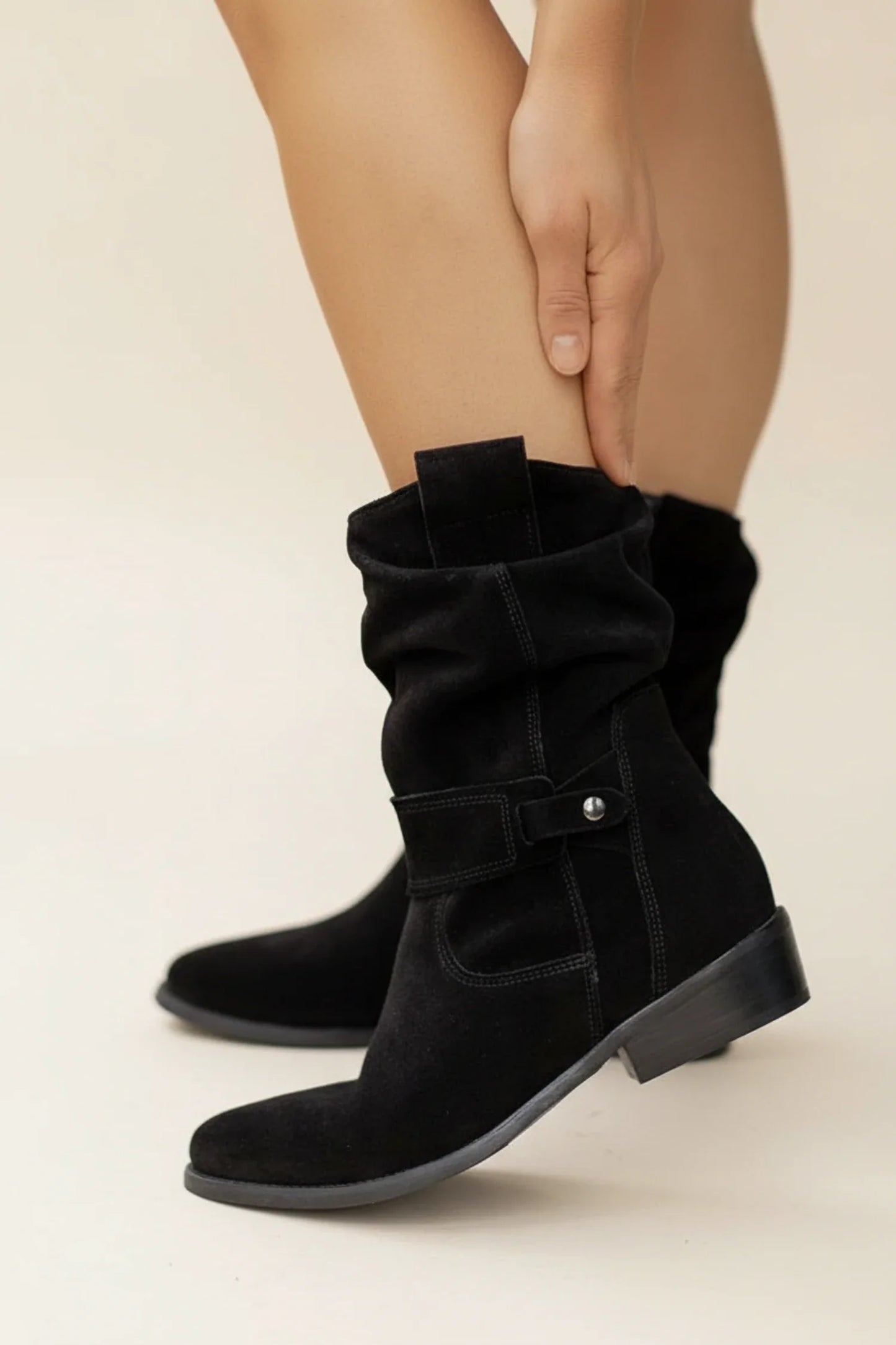 Women's brown slouch ankle boots with relaxed gathered shaft and statement buckle detail