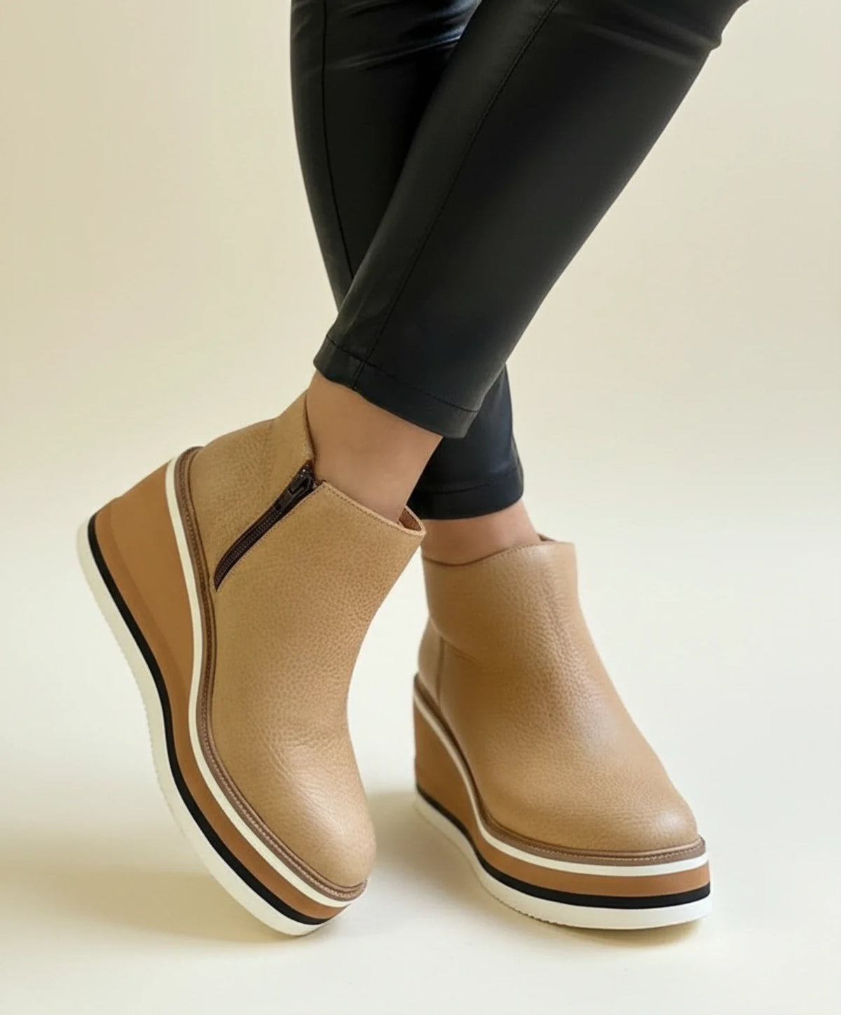 Women's black leather wedge boots with platform sole, polished silhouette and all-day comfort fit
