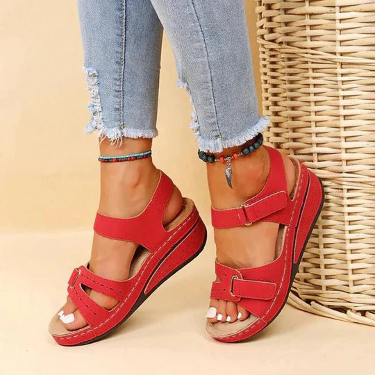 Women's flat walking sandals in neutral tone with adjustable twin buckle straps and open heel