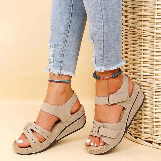 Women's flat walking sandals in neutral tone, open-toe twin-strap design with adjustable buckle closure